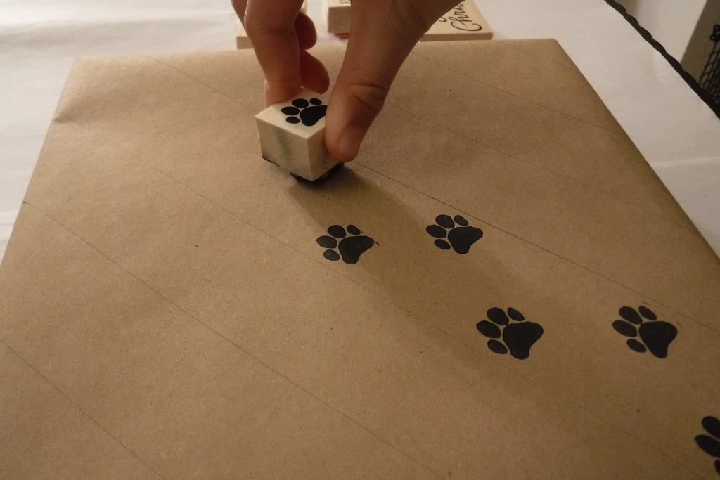 Stamped paw prints on gift wrap
