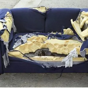 Ripped up blue couch 