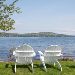 Dog Friendly Family Vacations in the Northeast - Two chairs looking out onto Lake Wnnipesaukee In New Hampshire