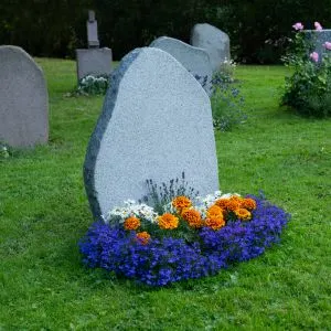 Pet Cemetery: Where to Find One Near You - Blank grave stone decorated with flowers.