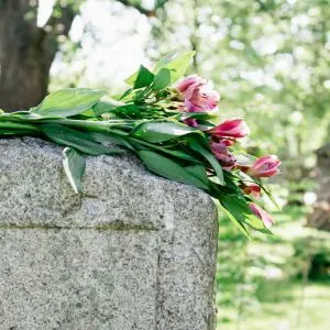 Pet Cemetery: Where to Find One Near You - Grave stone with flowers on top
