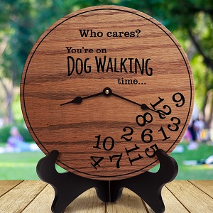Wooden clock with " Who cares? You're on Dog Walking time." with numbers in a gumble on the bottom of the clock. 