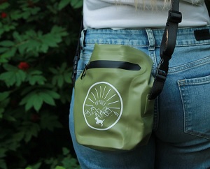 Smell Proof Poop Bag Carrier in green with black strap. 