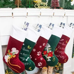 Holiday Traditions to Share With Your Dog - Christmas Stockings with dog theme hanging by the fireplace. 