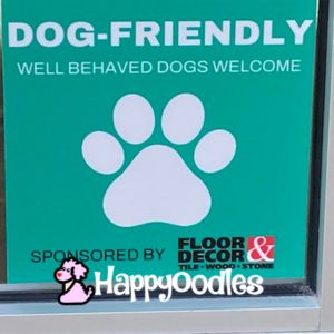 Dog friendly store sign with paw print and the words Dog Friendly - Well behaved dogs welcome