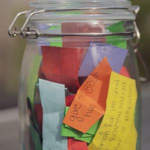 Clear canning jar filled with colorful paper