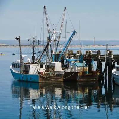 Title - Talk a walk along the pier. Picture of a fishing boats tied to the docks.
