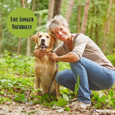 Happyoodles.com - Live Longer Naturally - Women with dog in the woods. 